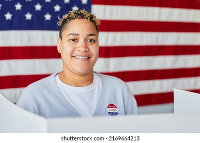 Portrait Of Smiling Black Woman Voting Against American Flag Background, Copy Space