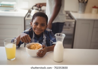 Portrait of smiling boy having breakfast cereals in kitchen. Social distancing and self isolation in quarantine lockdown for Coronavirus Covid19
 - Powered by Shutterstock