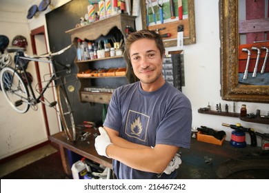 Portrait of smiling business owner in bicycle shop