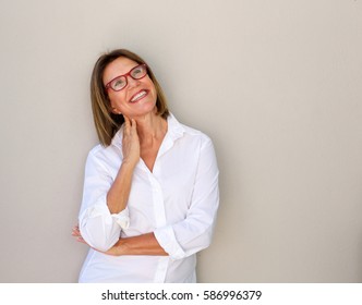 Portrait of smiling business woman with glasses looking up