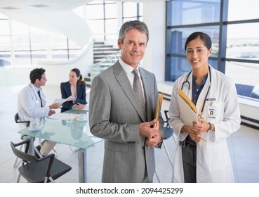 Portrait Of Smiling Businessman And Doctor In Meeting