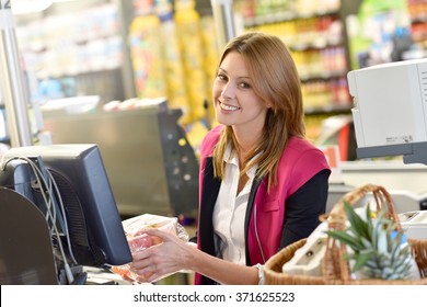 Portrait Of Smiling Cashier Working In Grocery Store