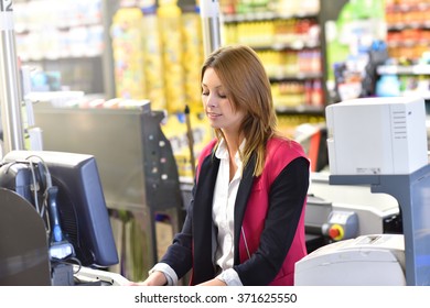 Portrait Of Smiling Cashier Working In Grocery Store