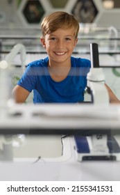 Portrait Of Smiling Caucasian Elementary Schoolboy Sitting At Desk In Science Laboratory. Unaltered, Education, Childhood, Learning, Science, Stem And School Concept.