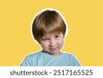 Portrait of smiling charming little toddler boy. He is giving a wink. Isolated on yellow background