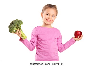 Portrait Of A Smiling Child Holding Broccoli And Apple Isolated On White Background