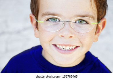 Portrait Of A Smiling Child Wearing Glasses