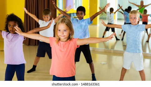 Portrait Of Smiling Children Practicing Sport Dance In Modern Dance Hall