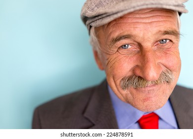 Portrait Of A Smiling And Confident Senior Good Looking Business Man With Hat