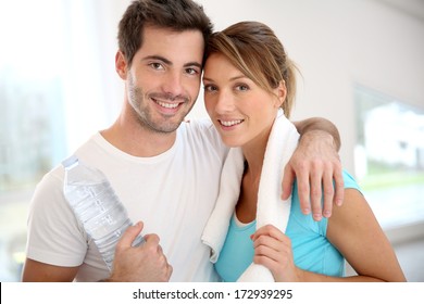 Portrait Of Smiling Couple In Fitness Gym