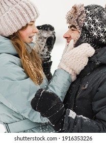 Portrait of smiling couple in love looking at each other. Young happy couple walking in winter day