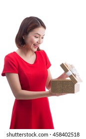 Portrait Of A Smiling Cute Asian Woman Opening Gift Box Isolated On A White Background