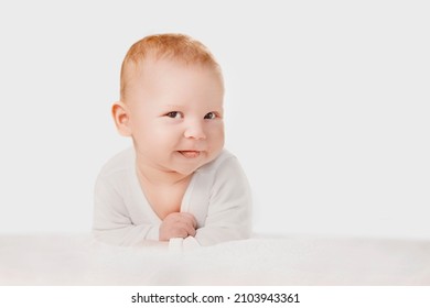 Portrait of smiling cute baby boy or baby girl in nursery. Baby care and childcare concept. Срild is playing, naughty, showing the tongue