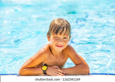 Portrait Of Smiling Cute Boy Swiming And Having Fun In The Pool, Closeup