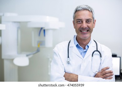 Portrait of smiling dentist in dental clinic - Shutterstock ID 474055939