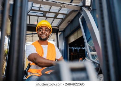 Portrait of smiling diverse forklift operator driving forklift at industry zone. - Powered by Shutterstock