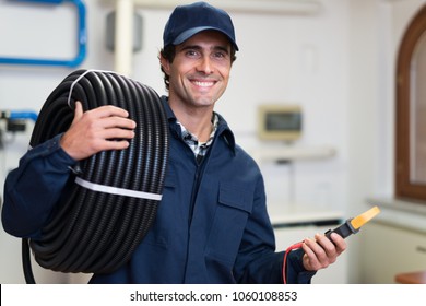 Portrait Of A Smiling Electrician At Work