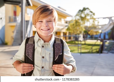 Portrait Of Smiling Elementary School Boy With His Backpack