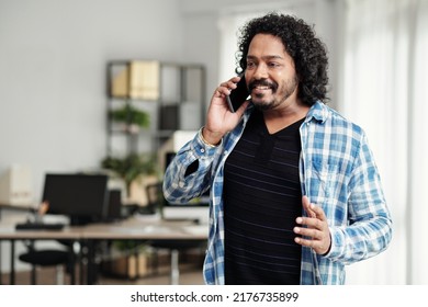 Portrait Of Smiling Excited Startup Founder Talking On Phone With Investor