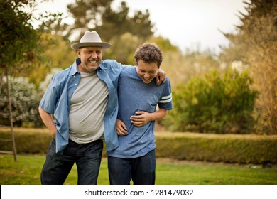 Portrait Of A Smiling Father And Teenage Son.