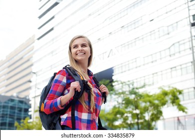 Portrait Of A Smiling Female College Student Walking With Bag