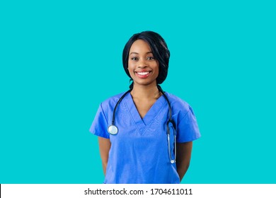 Portrait Of A Smiling Female Doctor Or Nurse Wearing Blue Scrubs Uniform And Stethoscope And Looking At Camera Isolated On Blue Background