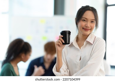 Portrait Of Smiling Female Entrepreneur Standing At Workplace