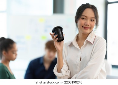 Portrait Of Smiling Female Entrepreneur Standing At Workplace