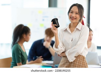 Portrait Of Smiling Female Entrepreneur Standing At Workplace