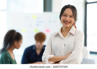 Portrait Of Smiling Female Entrepreneur Standing At Workplace