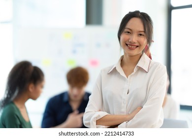 Portrait Of Smiling Female Entrepreneur Standing At Workplace