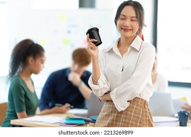 Portrait Of Smiling Female Entrepreneur Standing At Workplace