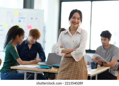 Portrait Of Smiling Female Entrepreneur Standing At Workplace