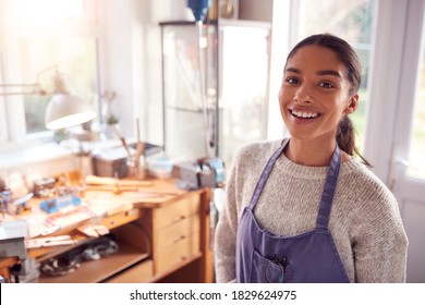 Portrait Of Smiling Female Jeweller At Bench Working In Studio - Powered by Shutterstock