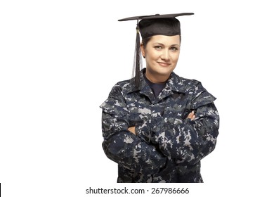 Portrait of smiling female navy sailor with graduation cap against white background