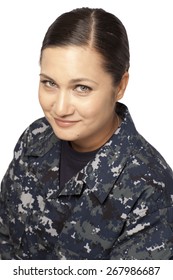 Portrait Of Smiling Female Navy Sailor Against White Background