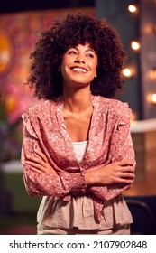 Portrait Of Smiling Female Server Working Night Shift In Bar Restaurant Or Club