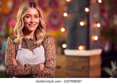 Portrait Of Smiling Female Server Working Night Shift In Bar Restaurant Or Club