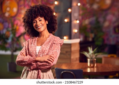 Portrait Of Smiling Female Server Working Night Shift In Bar Restaurant Or Club