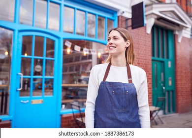 Portrait Of Smiling Female Small Business Owner Standing Outside Shop On Local High Street