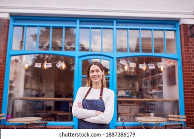 Portrait Of Smiling Female Small Business Owner Standing Outside Shop On Local High Street