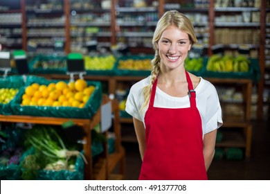 Portrait of smiling female staff standing in organic section of supermarket - Powered by Shutterstock