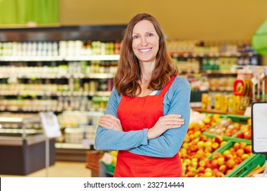 Portrait Of Smiling Female Store Manager In A Supermarket With Her Arms Crossed