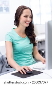 Portrait Of Smiling Female Student In Computer Class