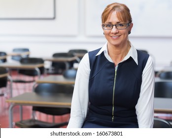 Portrait Of A Smiling Female Teacher In The Class Room