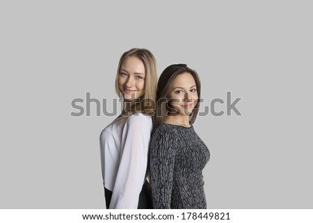 Similar – Image, Stock Photo Twin sisters stand laughing back to back in front of a stone wall