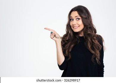 Portrait Of A Smiling Girl Pointing Finger Away Isolated On A White Background