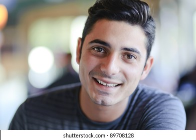 Portrait Of Smiling Handsome Brunet Young Man