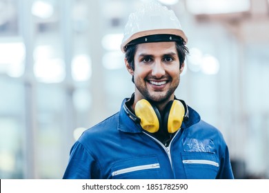 Portrait of smiling handsome industrial engineer worker wearing safety helmet and uniform in modern technology industry manufacturing. reopen industrial factory company. copy space  - Shutterstock ID 1851782590