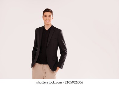 Portrait of smiling, handsome teenage boy in elegant clothes . Studio shot. Teen fashion. Real people emotions. A lot of copy space.
